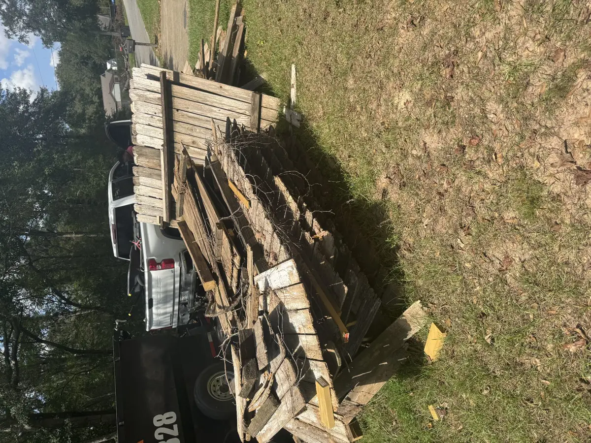 Clearout Junk trailer loaded with old wooden fence pickets and rails in Conroe TX 77301
