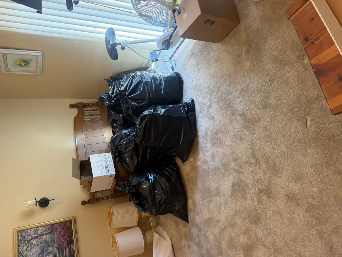 Bagged household items staged for removal during a house cleanout in Conroe TX