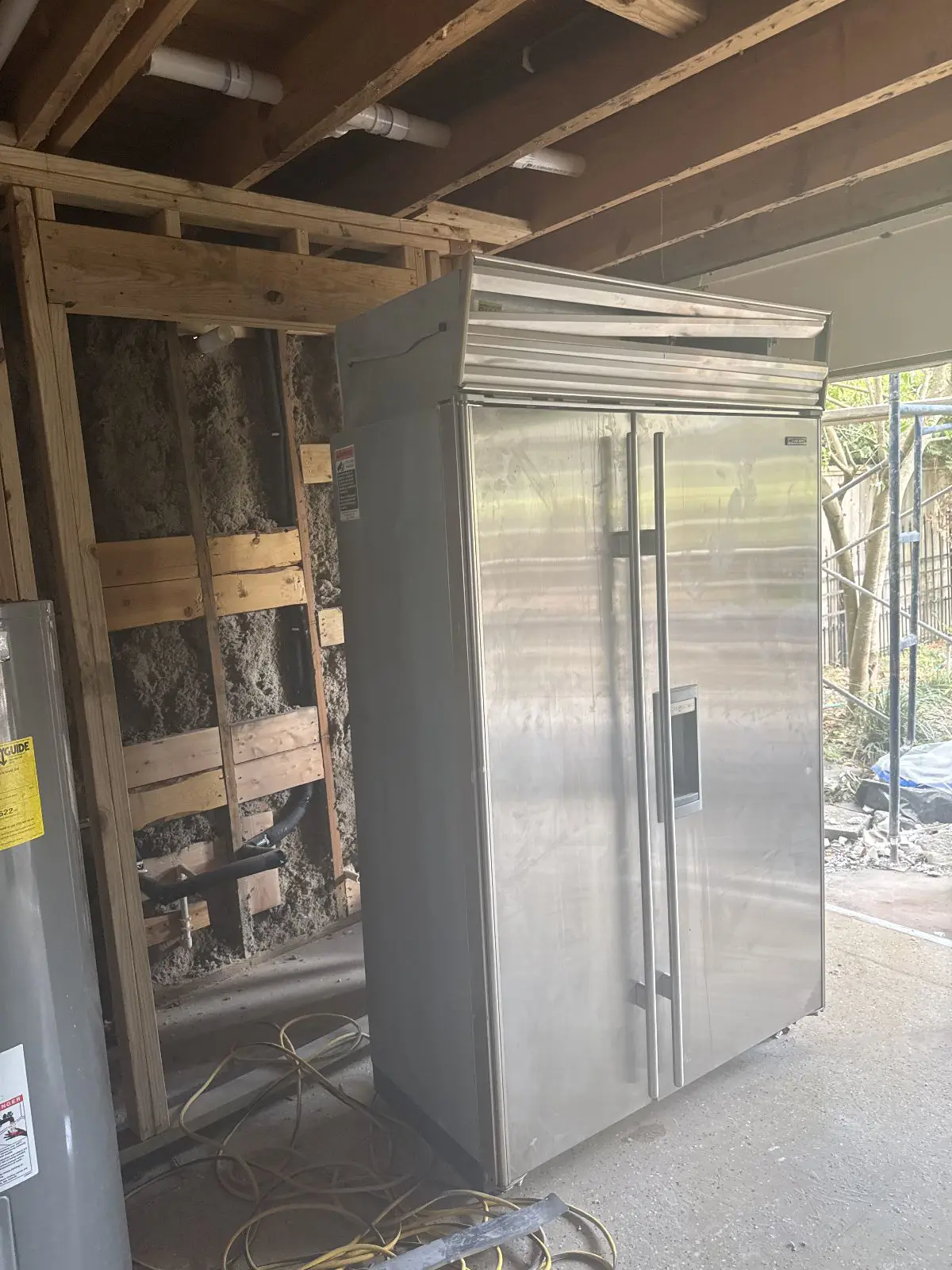 Built-in stainless refrigerator removed during kitchen renovation in Grogans Mill The Woodlands TX